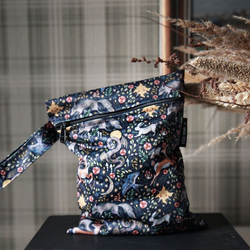 Eco Mini small wet bag with animal print on a dark surface