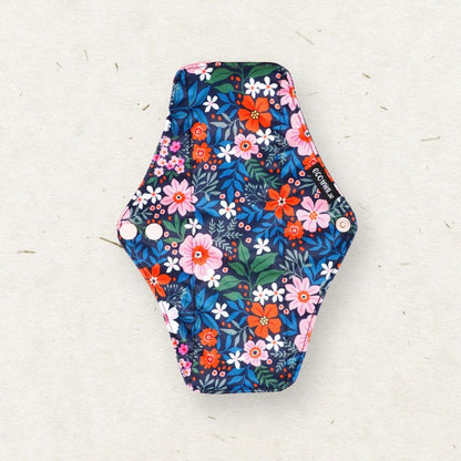 Eco Mini - Hexagonal floral-patterned cloth sanitary pad on a light gray background