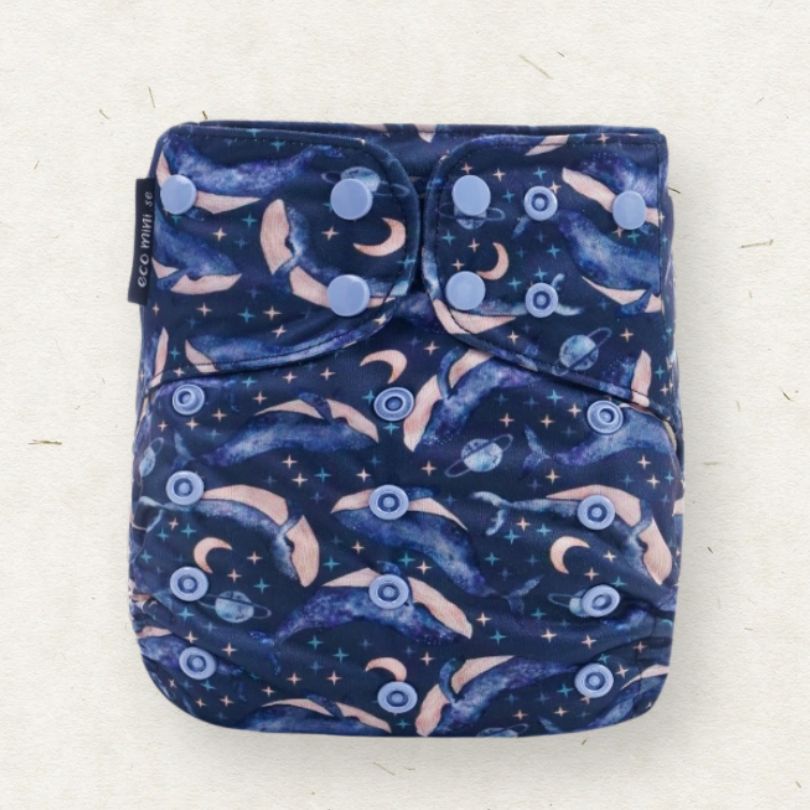 Eco Mini reusable cloth diaper with whale-themed pattern on a white background