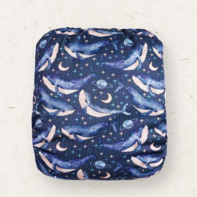 Eco Mini reusable cloth diaper with whale-themed pattern on a white background