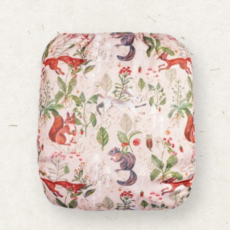 Fabric with a nature-themed pattern featuring animals and plants on a white background