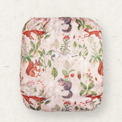 Fabric with a nature-themed pattern featuring animals and plants on a white background