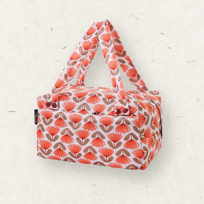 Eco Mini Cloth Diaper POD - with a repeating coral-orange and brown floral pattern on a white background, photographed against a light textured neutral backdrop.