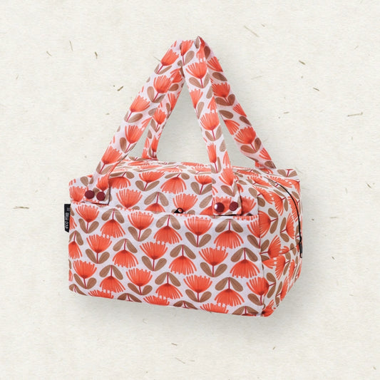 Eco Mini Cloth Diaper POD - with a repeating coral-orange and brown floral pattern on a white background, photographed against a light textured neutral backdrop.