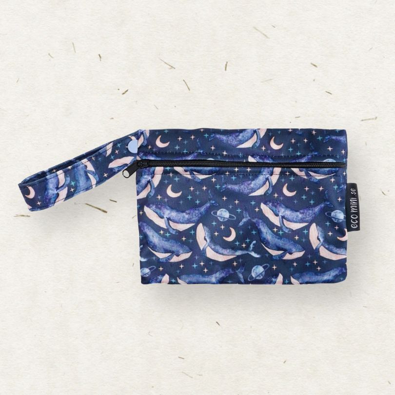 Eco Mini wet bag with whale pattern on a light gray background