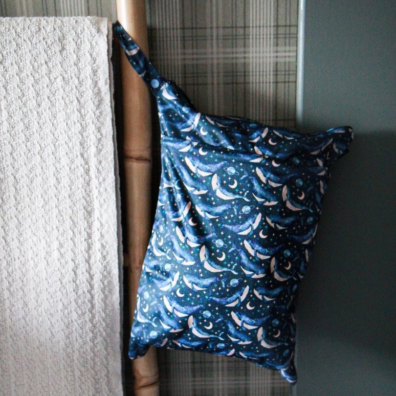 Eco Mini wet bag with whales print hanging on towel rail