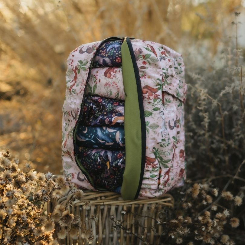 Eco Mini Cloth Diaper POD - squirrels print on a wooden surface with dried plants in the background