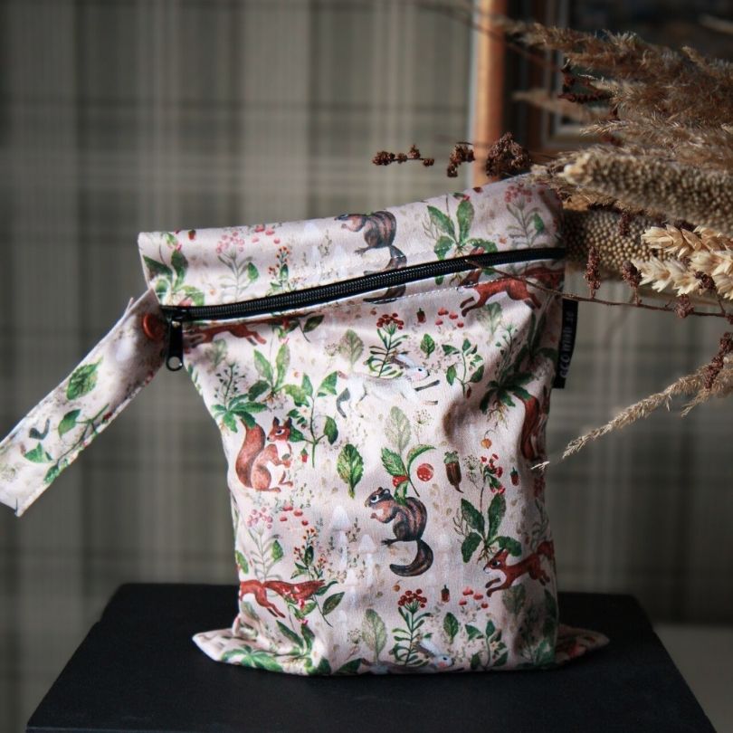 Eco Mini small wet bag with animal print on a dark surface