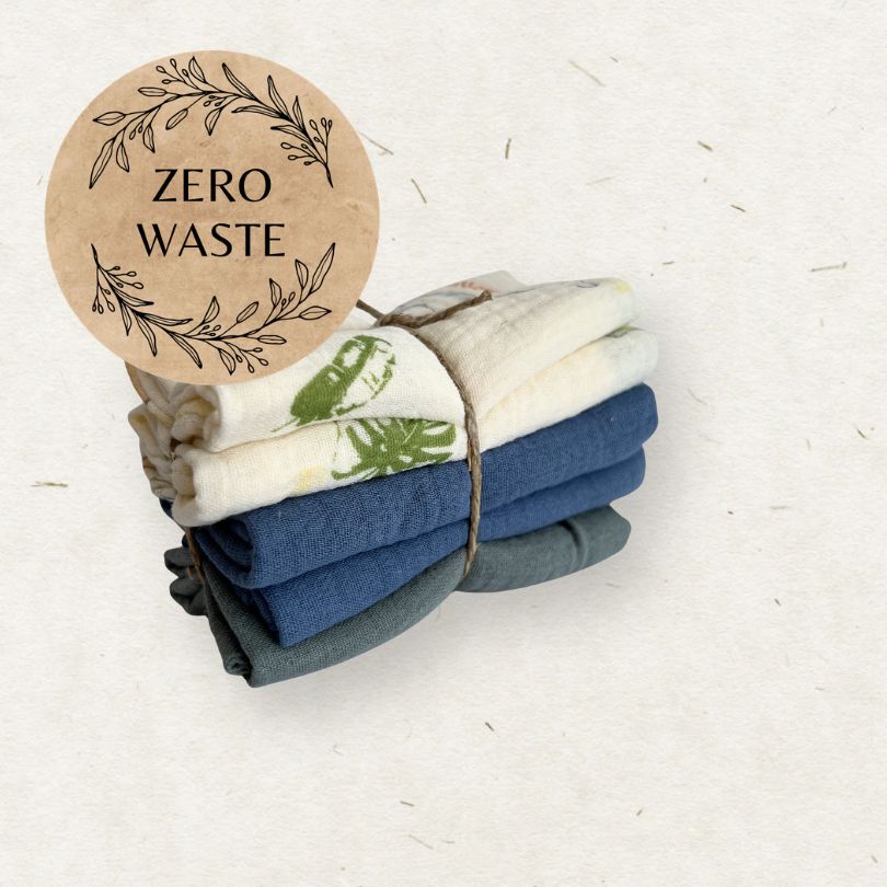 Stack of folded towels with a 'Zero Waste' label on a light background