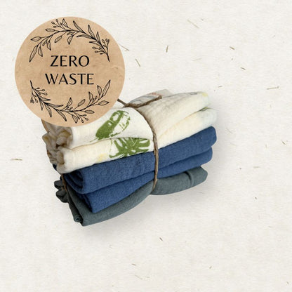 Stack of folded towels with a 'Zero Waste' label on a light background