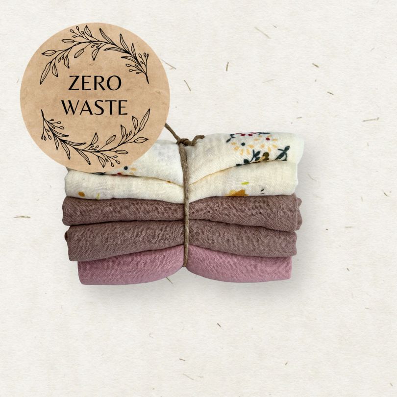 Stack of folded fabric wipes with a 'Zero Waste' sign on a light background