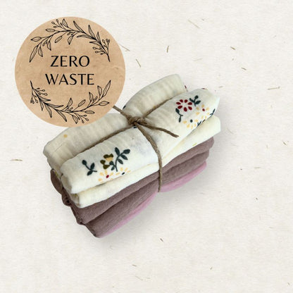 Stack of folded towels with a 'Zero Waste' label on a light background