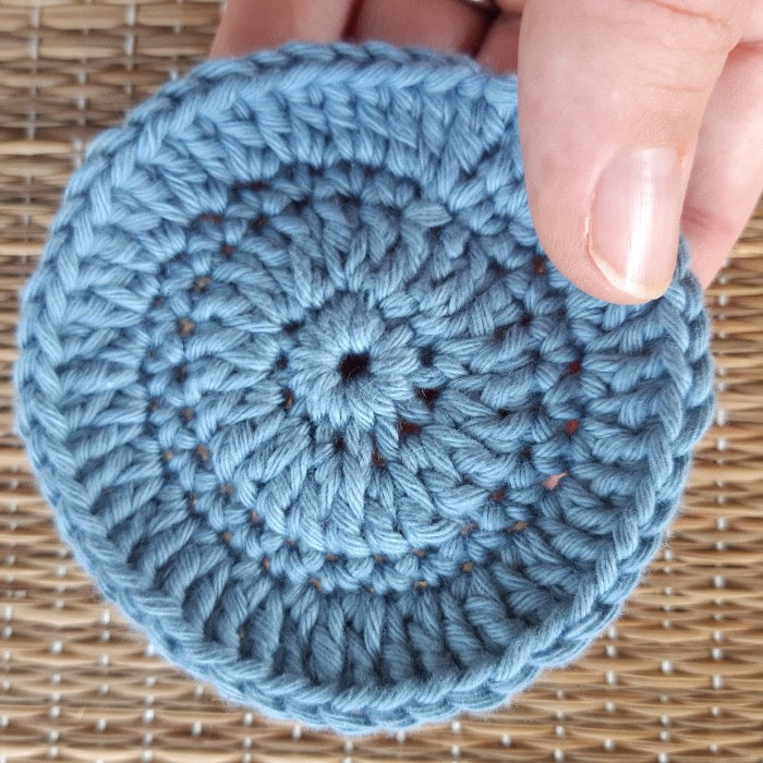 Pale blue crocheted face scrubby