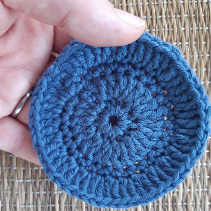 Blue crocheted face scrubby