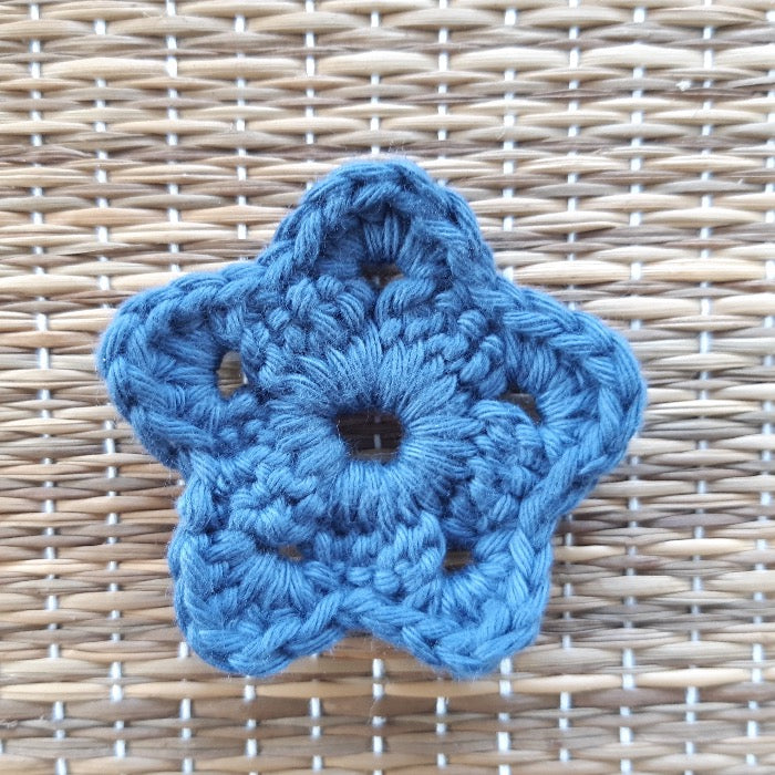 Blue flower shaped face scrubby